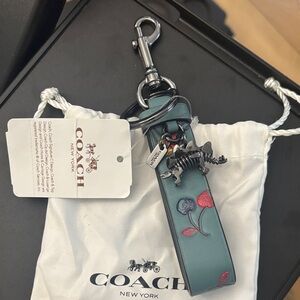 Coach dinosaur leather keychain with cherries - triceratops